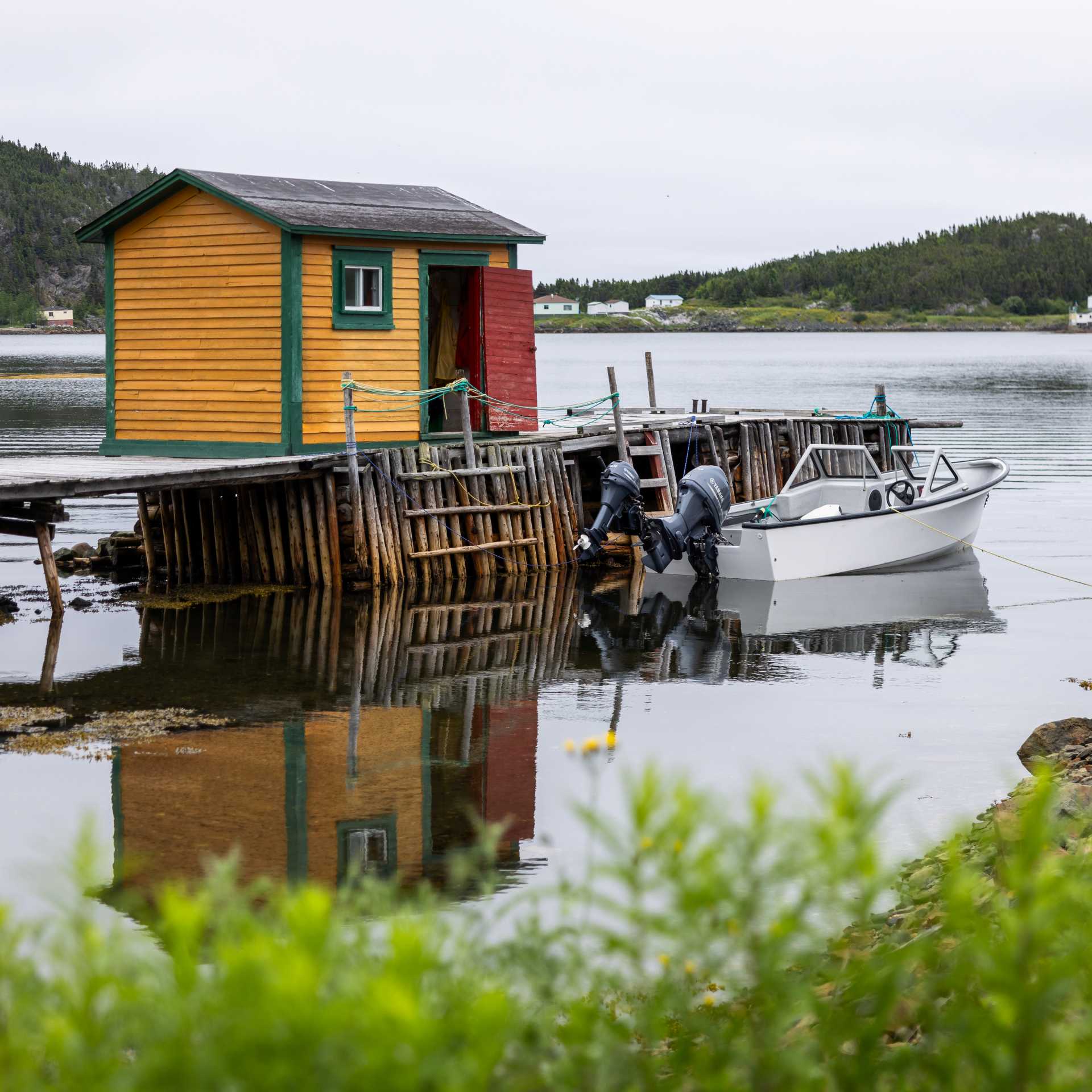 A traditional fishing stage and small boat reflect the life of a Newfoundland outport community | Tom Cochrane