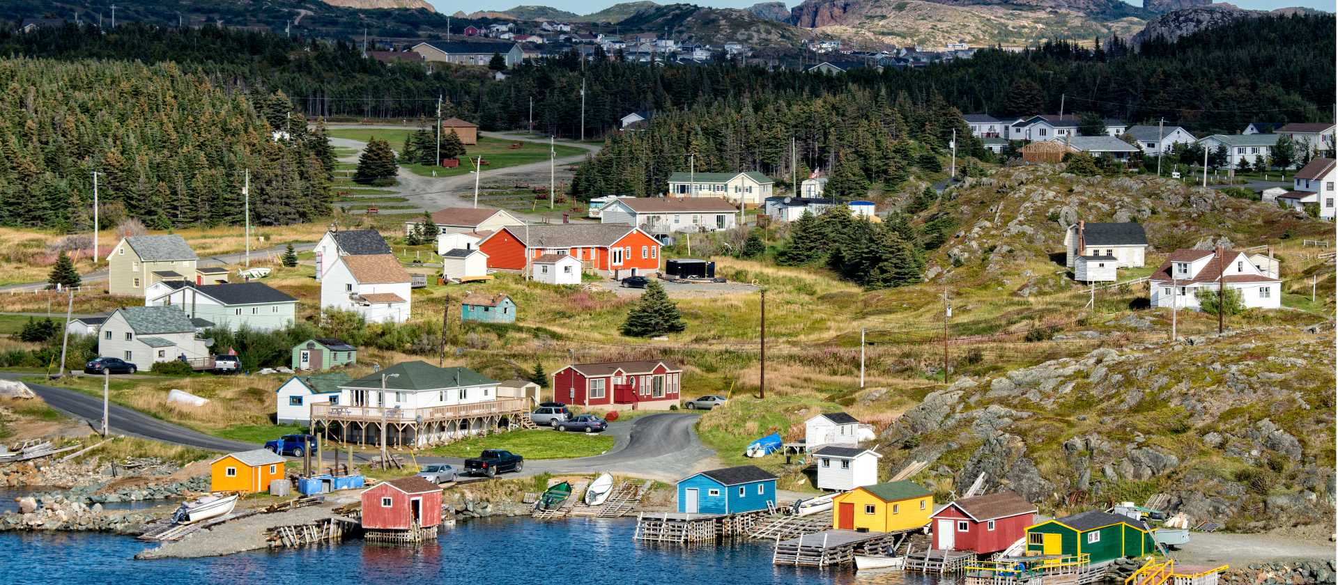 Colourful boat houses and homes line the shore of a traditional Newfoundland outport village | Dennis Minty