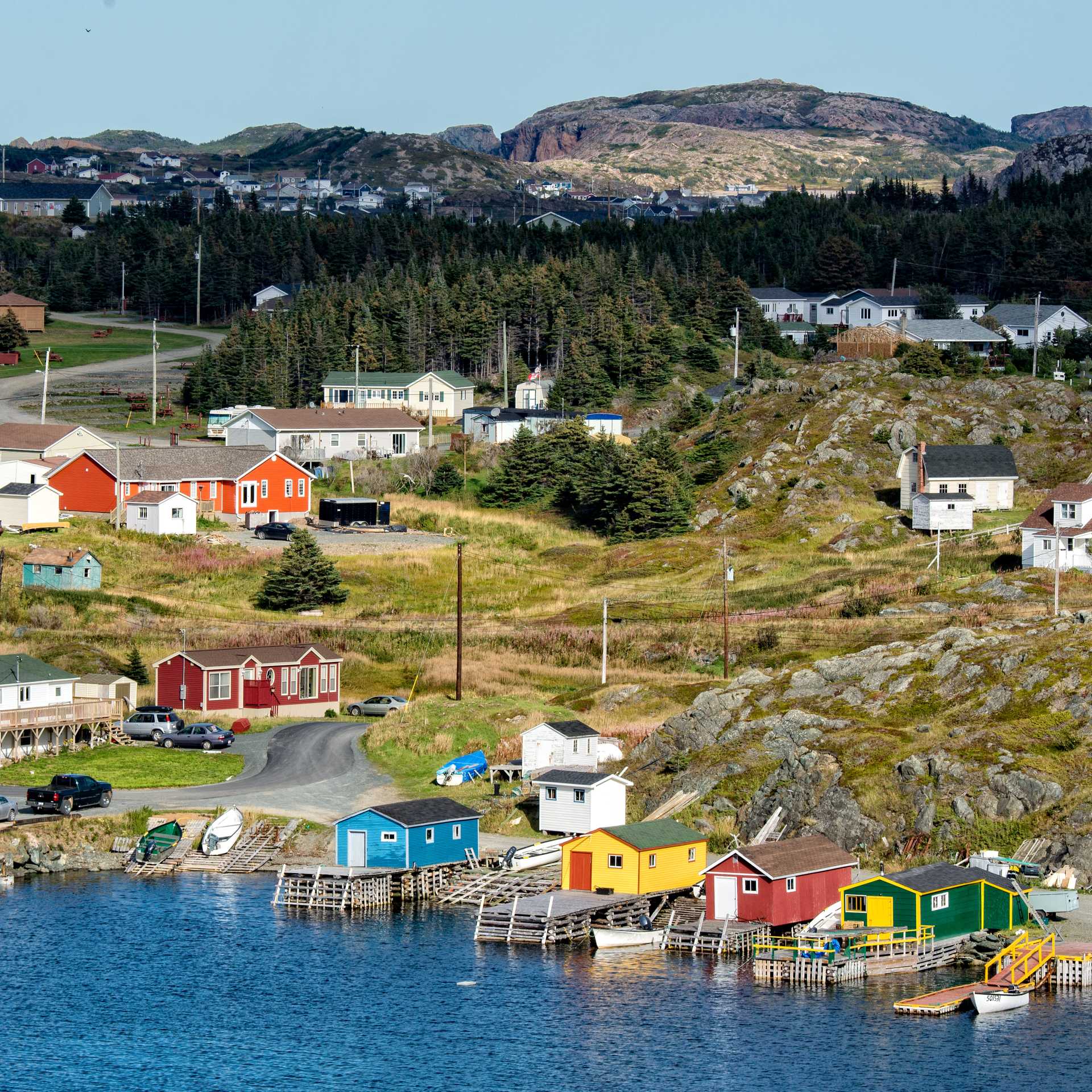 Colourful boat houses and homes line the shore of a traditional Newfoundland outport village | Dennis Minty