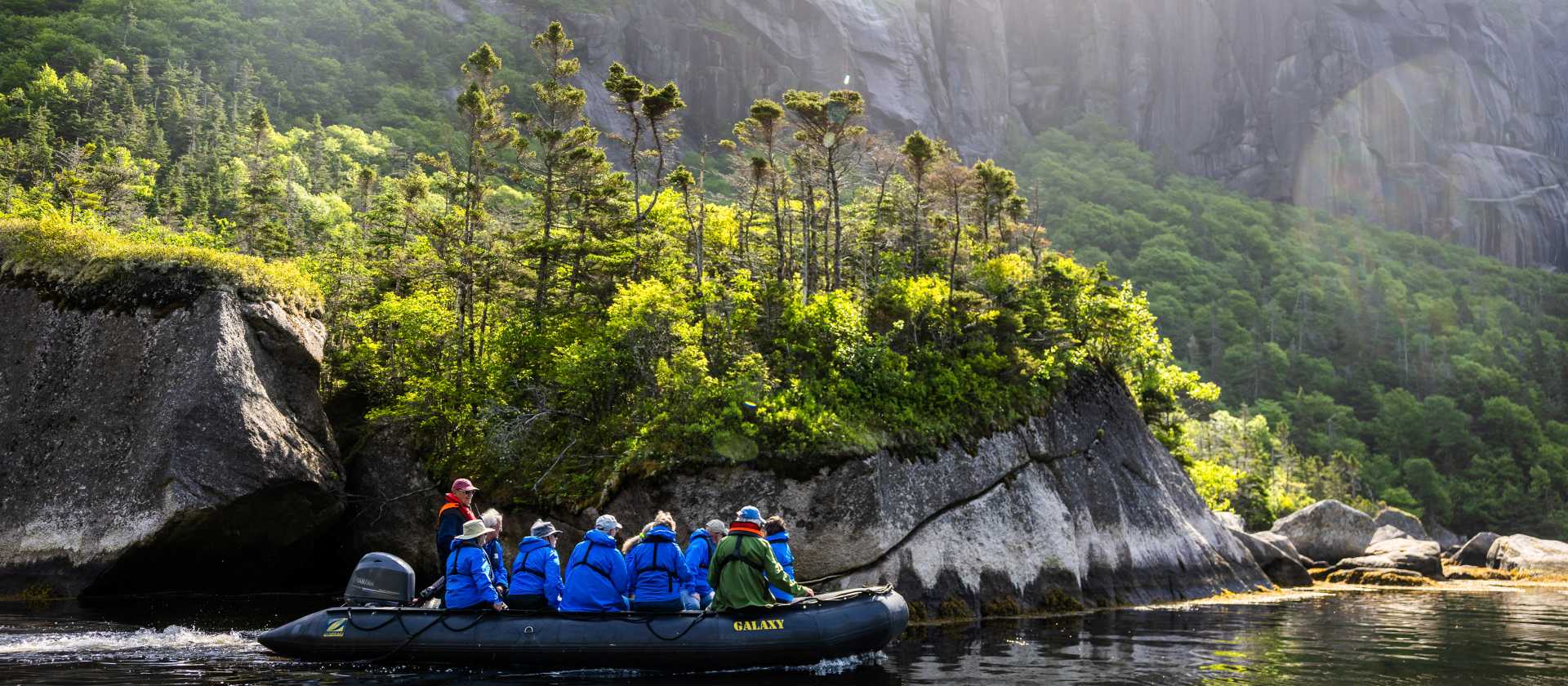 Travellers explore a dramatic landscape by Zodiac | Tom Cochrane
