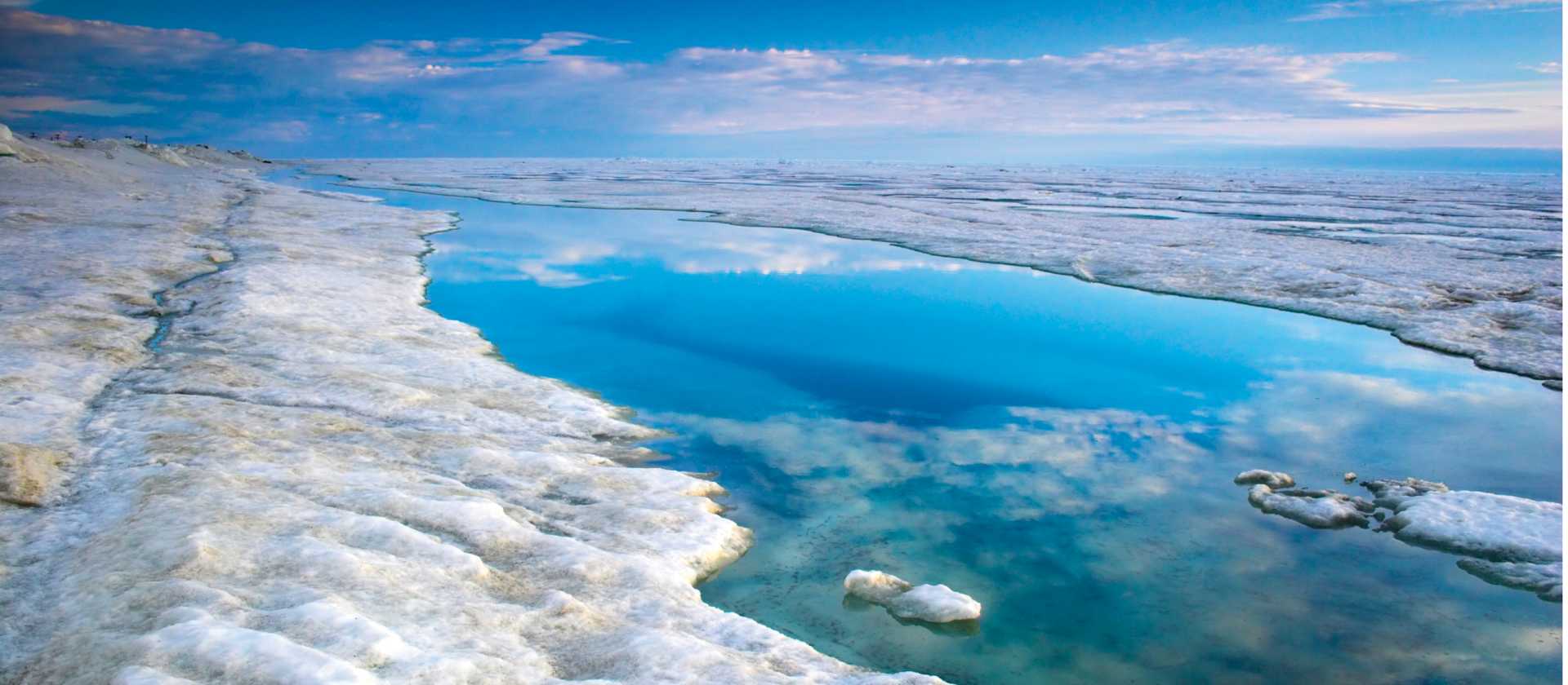 The blue sky is reflected in the Arctic Ocean