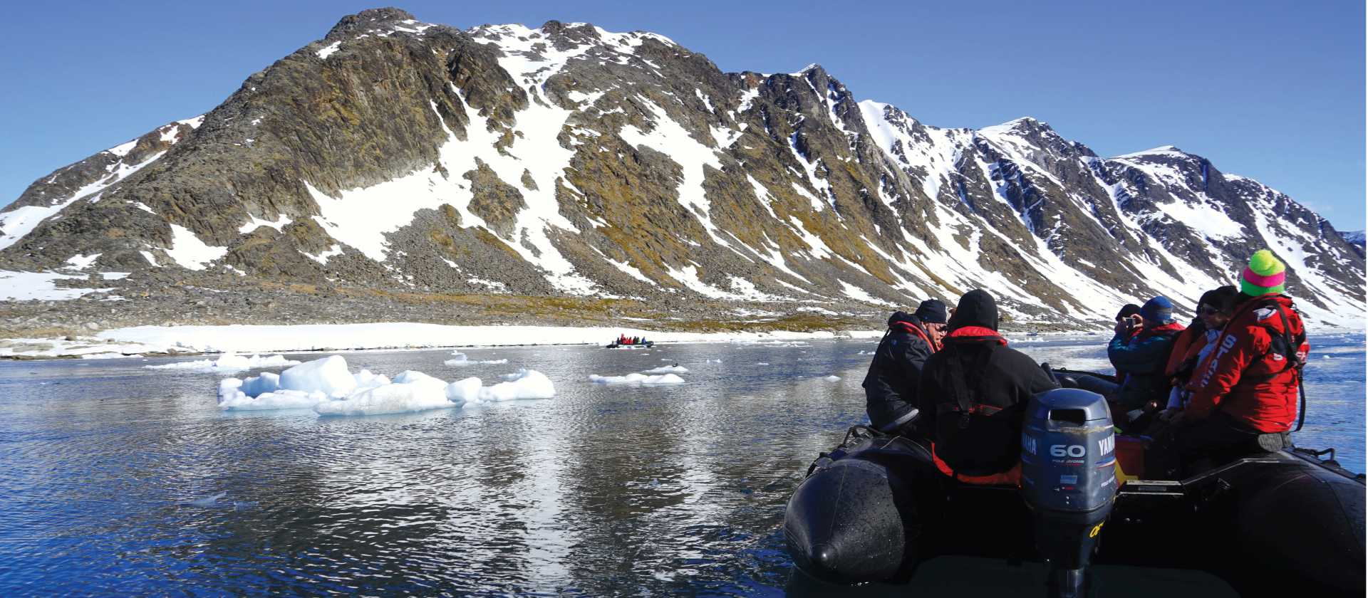 Zodiac cruising the calm Arctic Ocean | Gesine Cheung