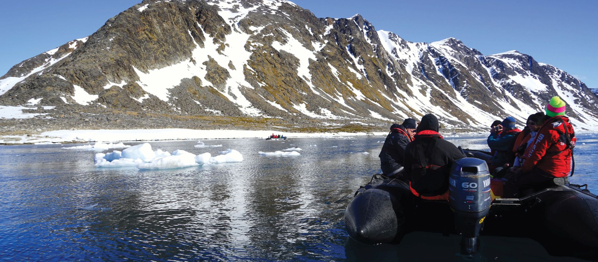 Zodiac cruising the calm Arctic Ocean | Gesine Cheung