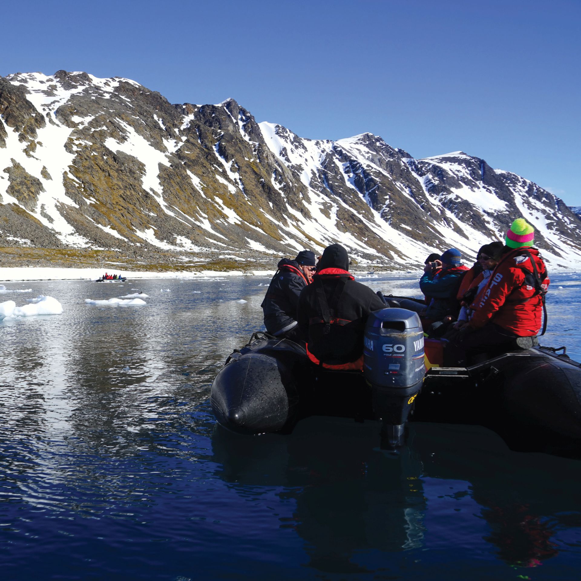 Zodiac cruising the calm Arctic Ocean | Gesine Cheung