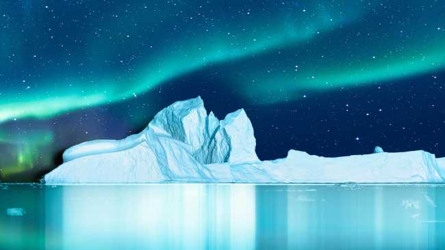 Aurora Borealis lights up the fjord in Greenland