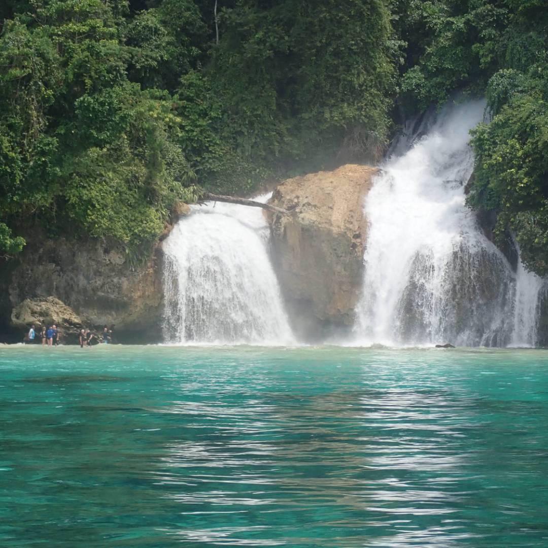 Kiti Kiti Waterfalls cascade into the ocean off the coast of West Papua