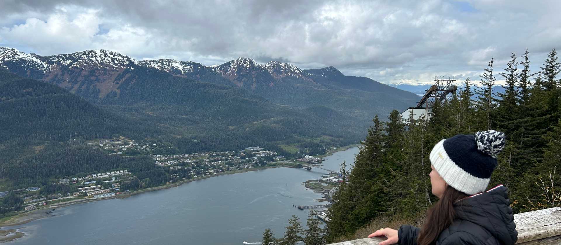 A visitor overlooks a coastal town | Lorena Marques