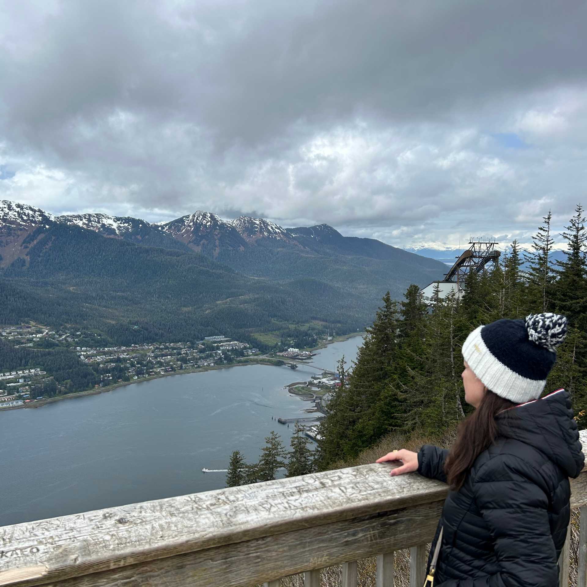 A visitor overlooks a coastal town | Lorena Marques