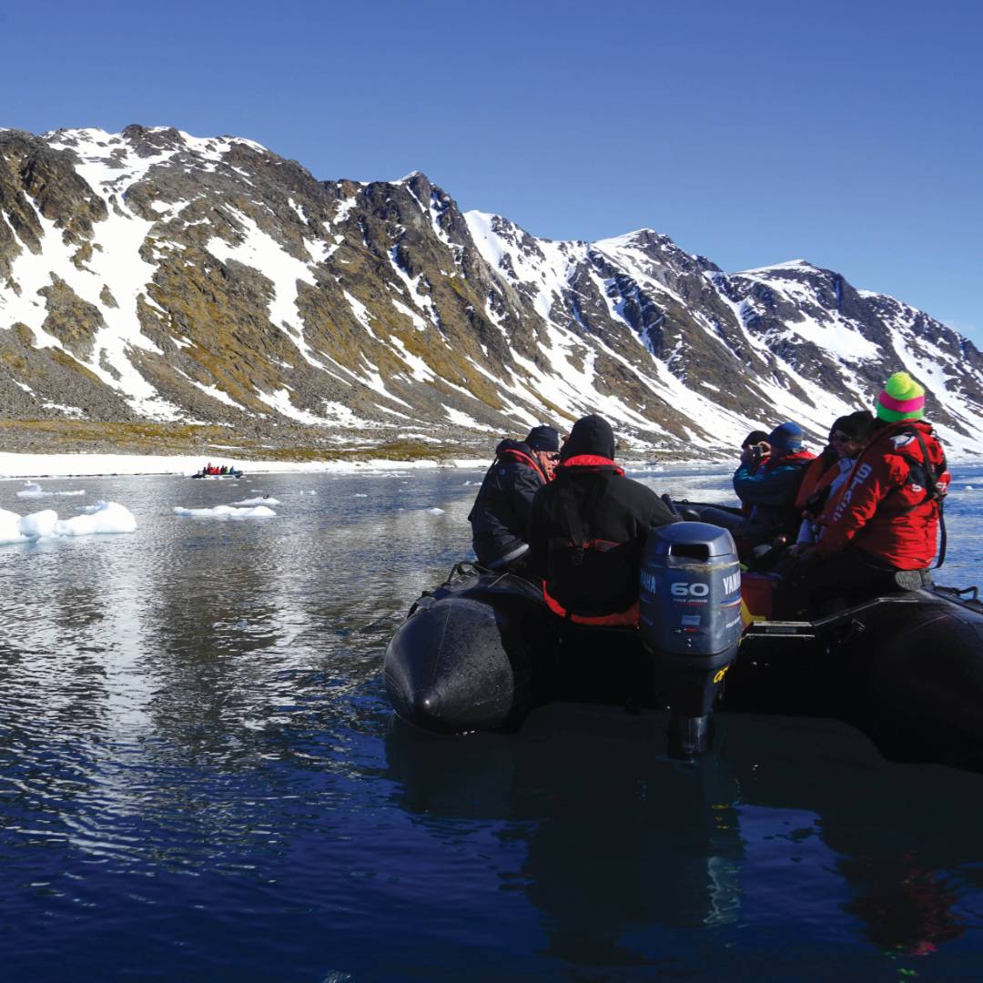 Zodiac cruising the calm Arctic Ocean | Gesine Cheung