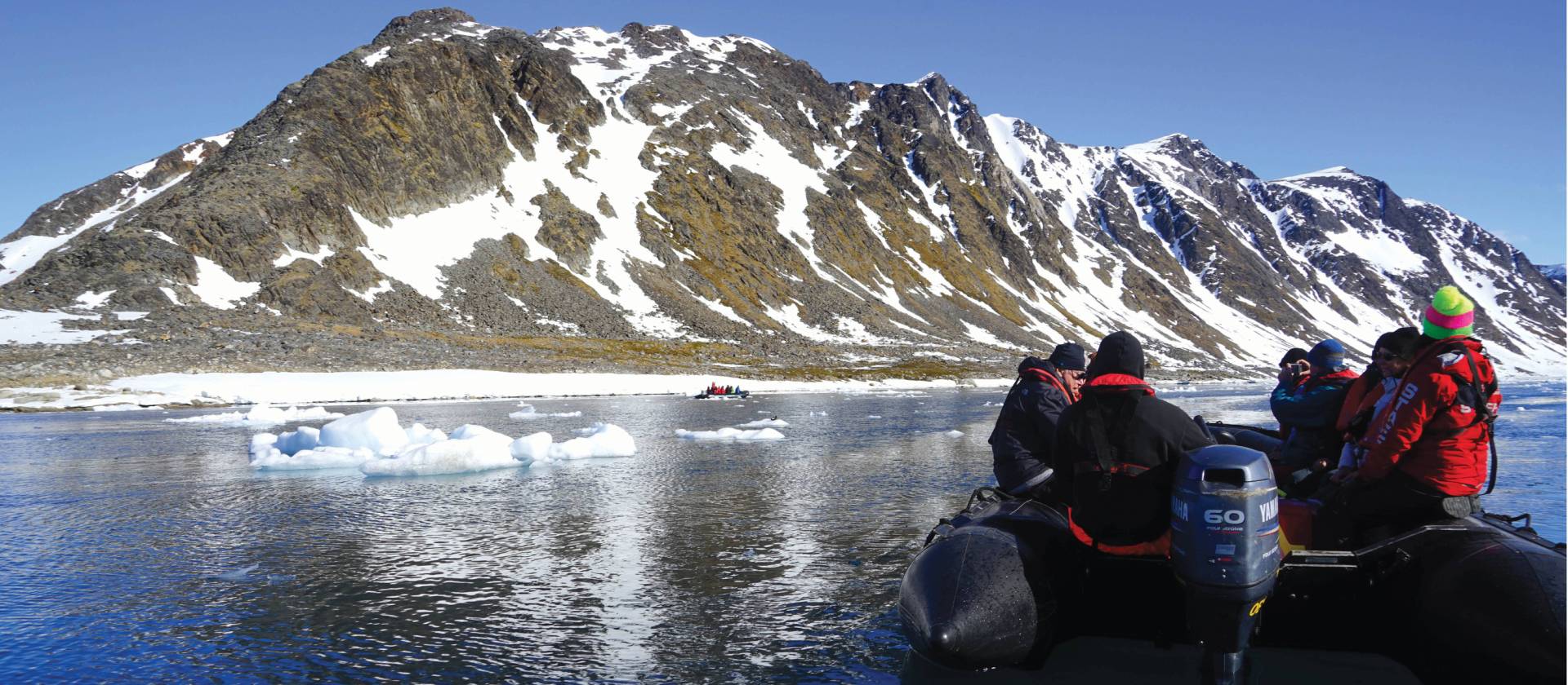 Zodiac cruising the calm Arctic Ocean | Gesine Cheung