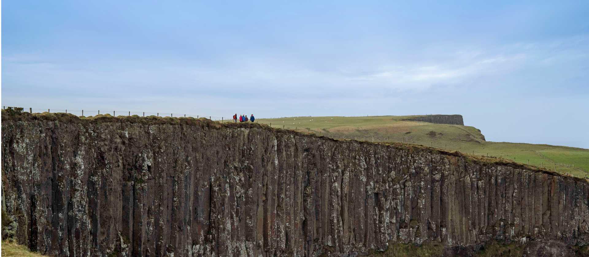 Hikers on the basalt cliffs of the Giant's Causeway | Rob Durston