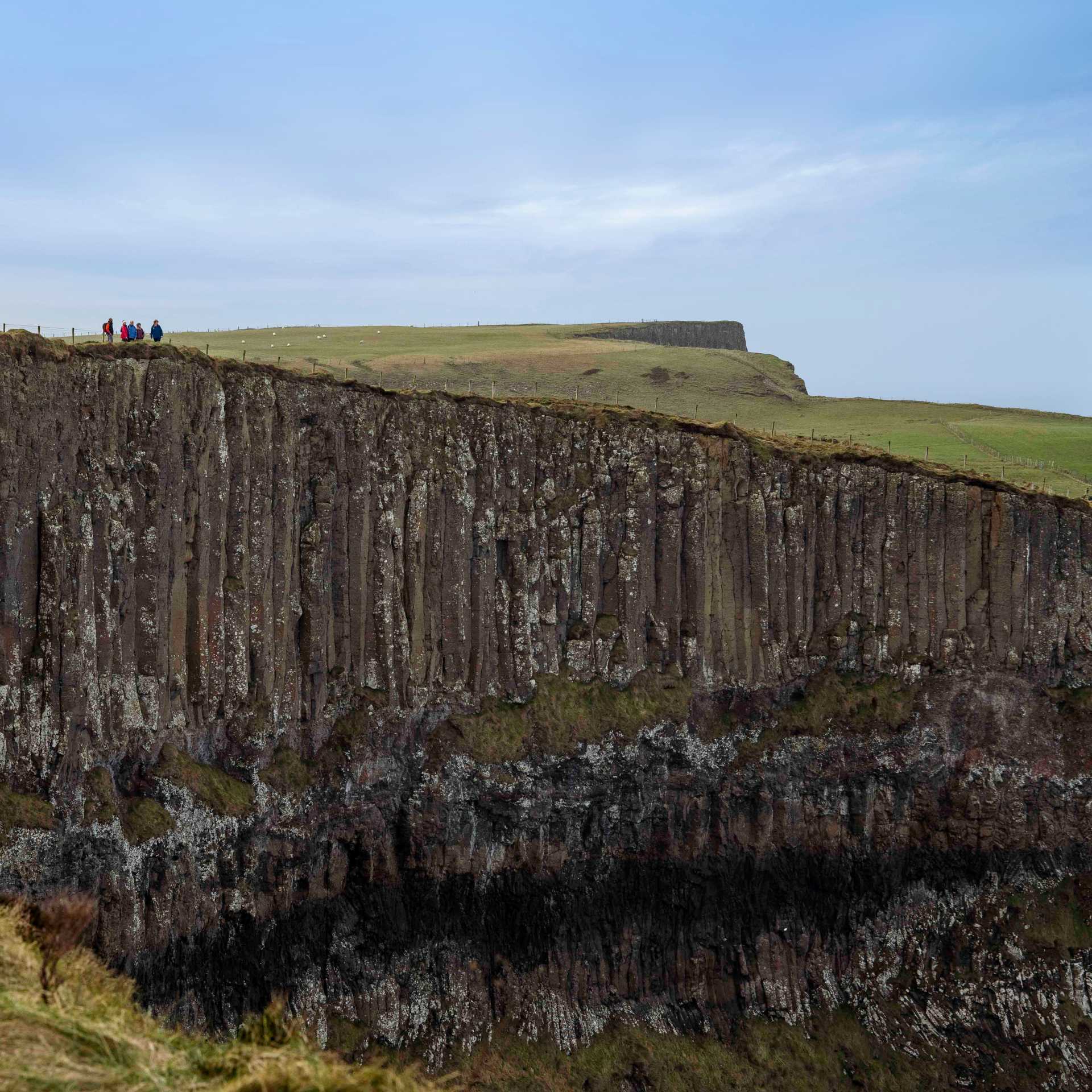Hikers on the basalt cliffs of the Giant's Causeway | Rob Durston